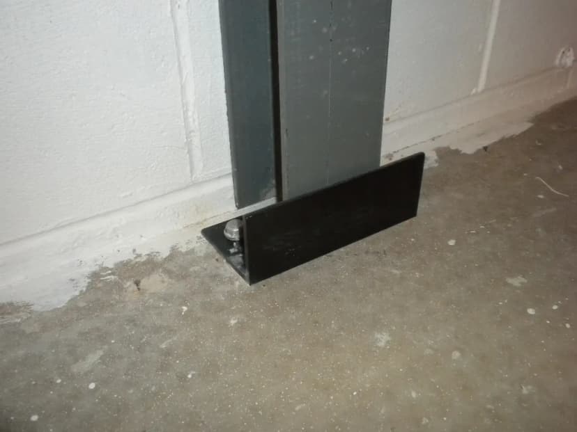 Floor bracket system installation for foundation wall stabilization